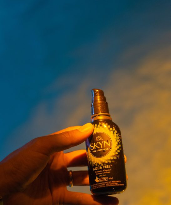 Hand holding SKYN Aqua Feel Lubricant